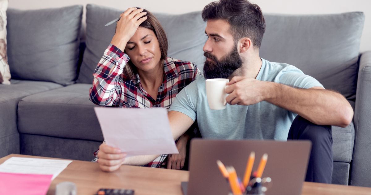 Young stressed couple trying to sort out expenses after car accident injures left them with economic damages.